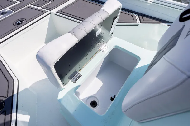 Slide: The Image of 2026 Excel 203 Bay Pro Elite boat seat with storage compartment open. - 18