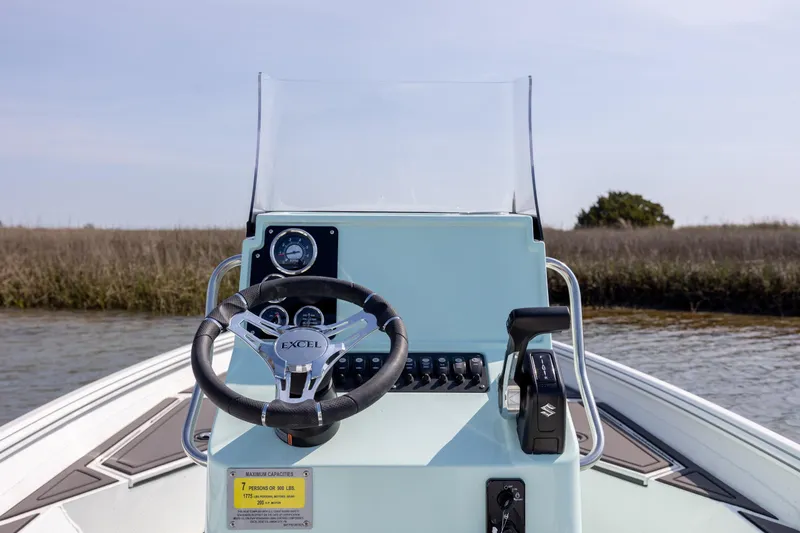 Slide: The Image of 2026 Excel 203 Bay Pro Elite boat dashboard with steering wheel and controls. - 21