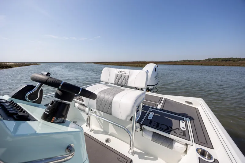 Slide: The Image of 2026 Excel 203 Bay Pro Elite boat on calm water, featuring sleek seating and controls. - 23