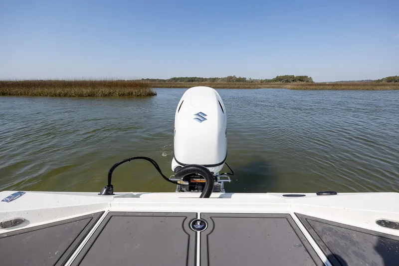 Slide: The Image of 2026 Excel 203 Bay Pro Elite boat on calm water with outboard motor. - 29