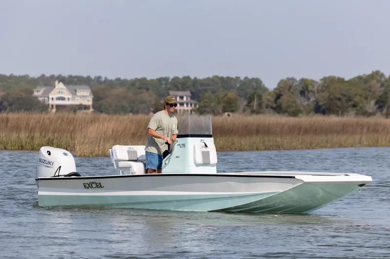 Slide: The Image of 2026 Excel 203 Bay Pro Elite boat cruising on a serene waterway. - 3