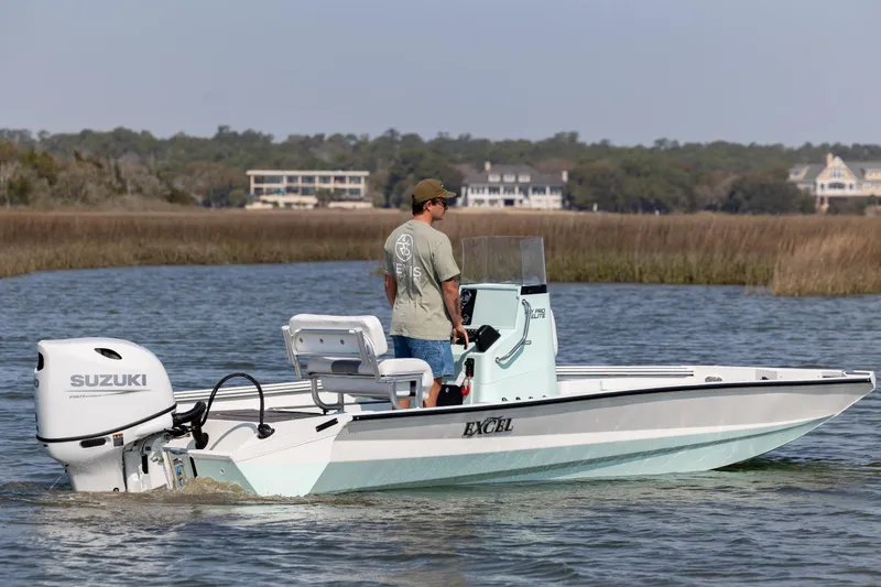 Slide: The Image of 2026 Excel 203 Bay Pro Elite boat with Suzuki engine on calm water. - 5
