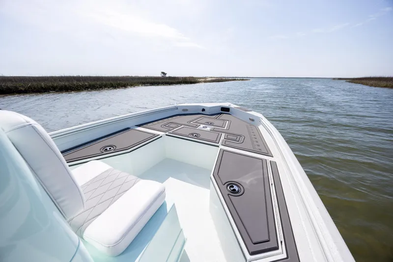 Slide: The Image of 2026 Excel 203 Bay Pro Elite boat on calm water, featuring sleek deck design. - 9