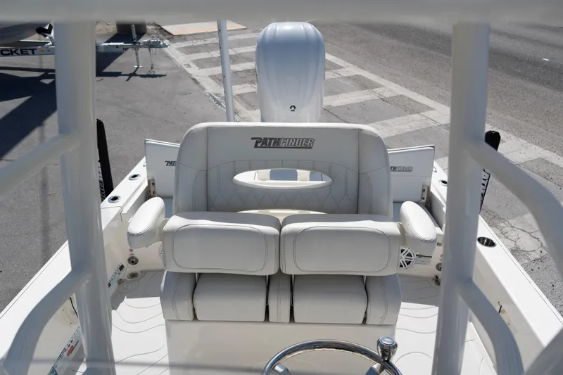 Slide: The Image of 2023 Pathfinder 2500 Hybrid boat interior with white seating and steering wheel. - 14