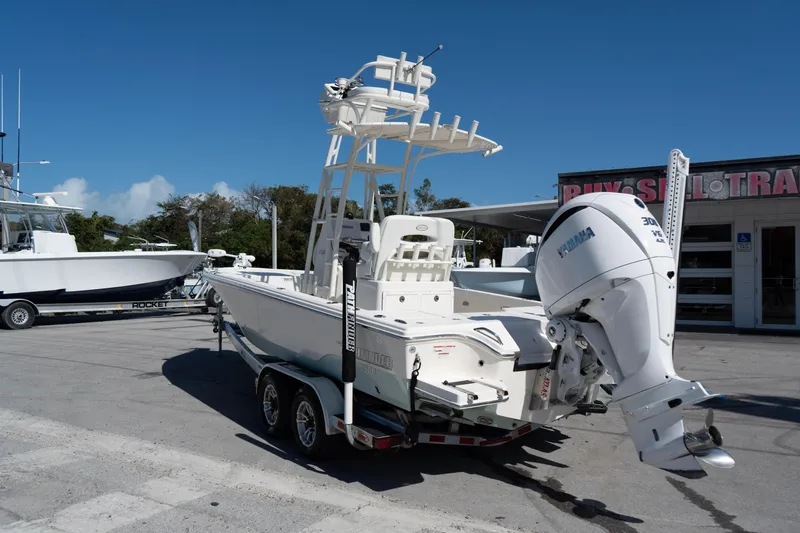 Slide: The Image of 2023 Pathfinder 2500 Hybrid boat with Yamaha engine on trailer, parked outdoors. - 4