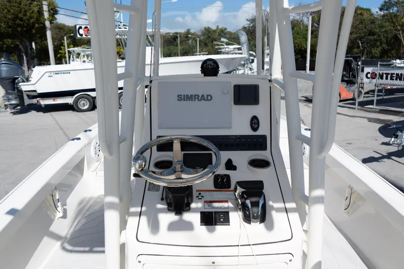 Slide: The Image of 2023 Pathfinder 2500 Hybrid boat console with Simrad navigation system and steering wheel. - 6