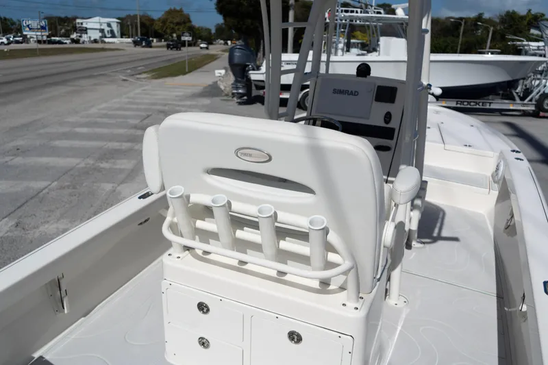 Slide: The Image of 2023 Pathfinder 2500 Hybrid boat interior with rod holders and Simrad navigation system. - 7