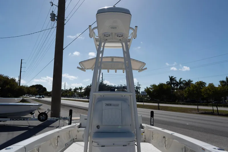 Slide: The Image of 2023 Pathfinder 2500 Hybrid boat with T-top, parked roadside under clear sky. - 8