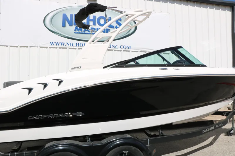 Slide: The Image of 2026 Chaparral 21 SSi boat in black and white on trailer at dealership. - 12