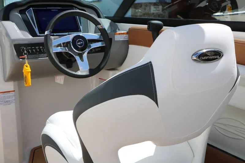 Slide: The Image of Interior of 2026 Chaparral 21 SSi boat with steering wheel and branded seat. - 29