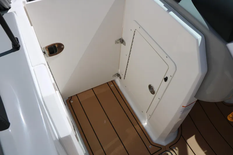 Slide: The Image of 2026 Chaparral 21 SSi boat interior with storage compartment and teak flooring. - 34