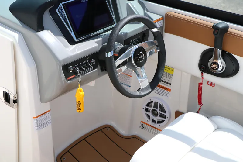 Slide: The Image of 2026 Chaparral 21 SSi boat dashboard with steering wheel and control panel. - 43