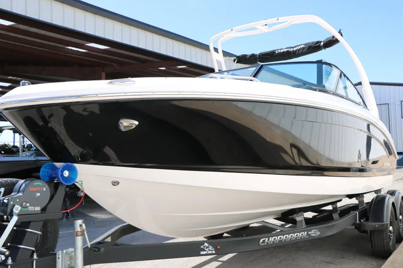 Slide: The Image of 2026 Chaparral 21 SSi boat on trailer, black and white exterior, parked outdoors. - 5