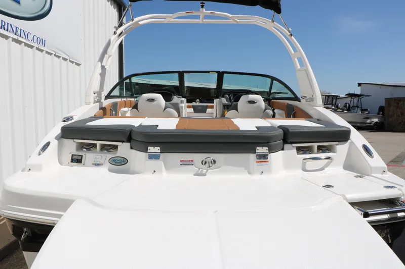Slide: The Image of 2026 Chaparral 21 SSi boat with sleek seating and modern design at a marina. - 8