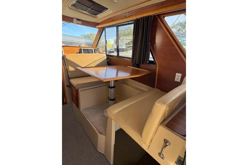 Slide: The Image of Interior of 2012 Cutwater C-26 boat with dining area and beige seating. - 11