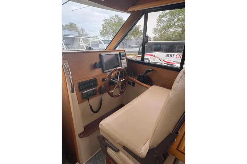 Slide: The Image of Interior helm of 2012 Cutwater C-26 boat with steering wheel and navigation controls. - 17