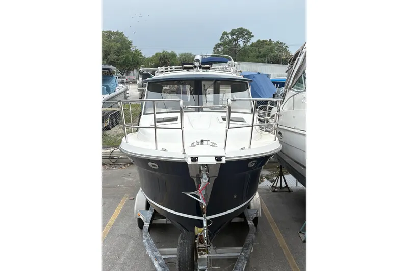 Slide: The Image of 2012 Cutwater C-26 boat on trailer, parked outdoors, front view. - 2
