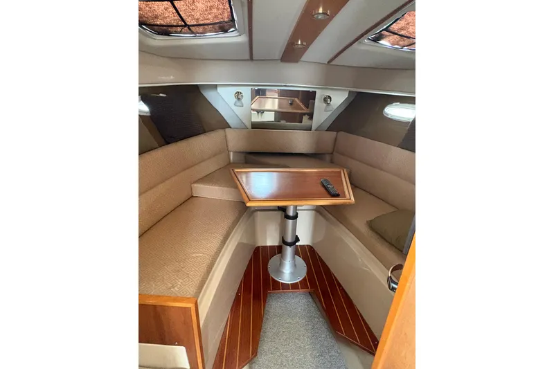 Slide: The Image of Interior of 2012 Cutwater C-26 boat with cozy seating and wooden table. - 21