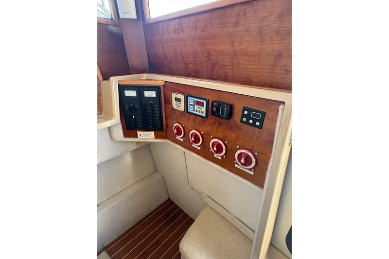 Slide: The Image of Control panel of a 2012 Cutwater C-26 boat with switches and gauges. - 24