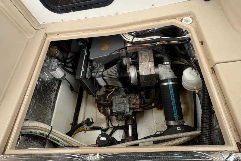 Slide: The Image of Engine compartment of a 2012 Cutwater C-26 boat, showcasing mechanical components and wiring. - 6