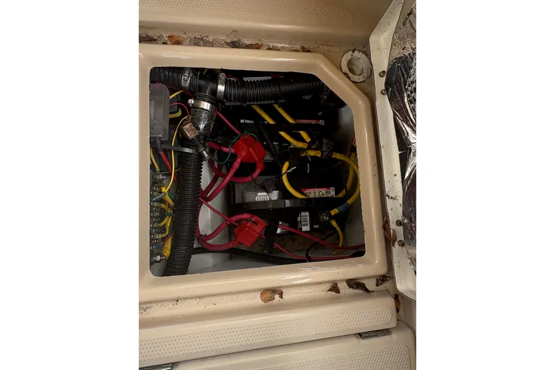 Slide: The Image of Electrical compartment of a 2012 Cutwater C-26 boat with visible wiring and components. - 7