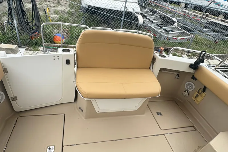 Slide: The Image of 2012 Cutwater C-26 boat interior with tan seating and storage compartments. - 9