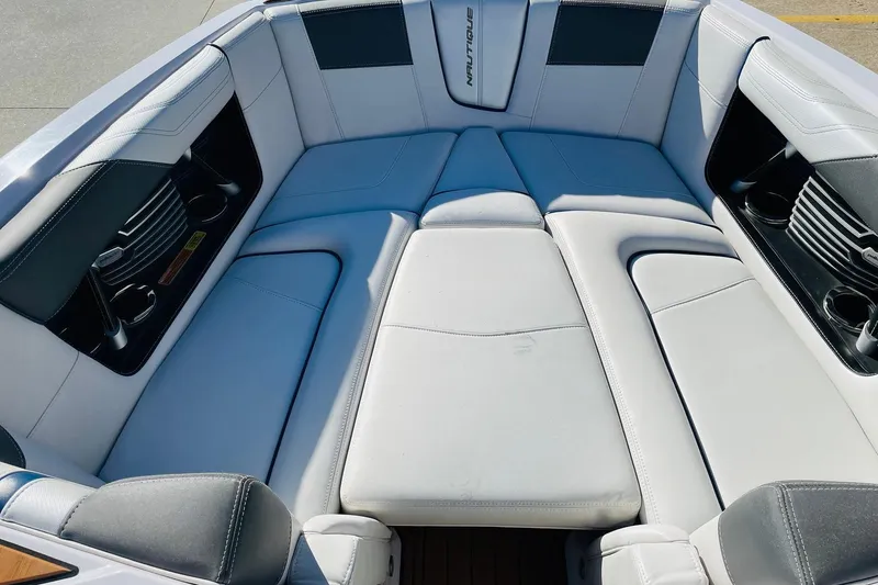 Slide: The Image of 2015 Nautique Super Air Nautique G23 boat interior with white cushioned seating. - 13