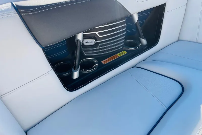 Slide: The Image of 2015 Nautique Super Air Nautique G23 interior with Polk Audio speaker and cup holders. - 14