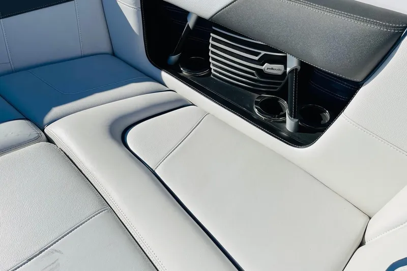 Slide: The Image of 2015 Nautique Super Air Nautique G23 interior with white seating and Polk Audio speakers. - 16