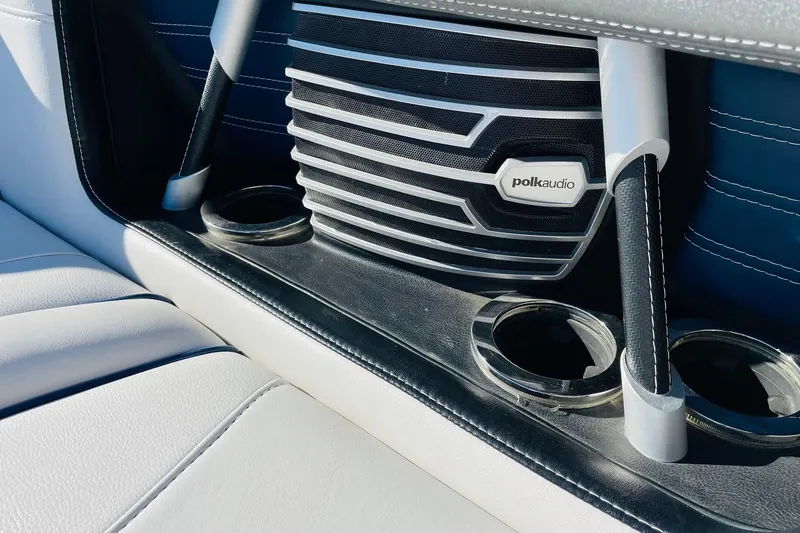 Slide: The Image of 2015 Nautique Super Air Nautique G23 interior with Polk Audio speaker and cup holders. - 17