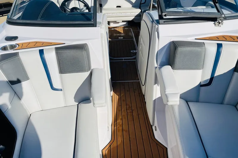 Slide: The Image of 2015 Nautique Super Air Nautique G23 interior with white and gray seating, wooden flooring. - 18