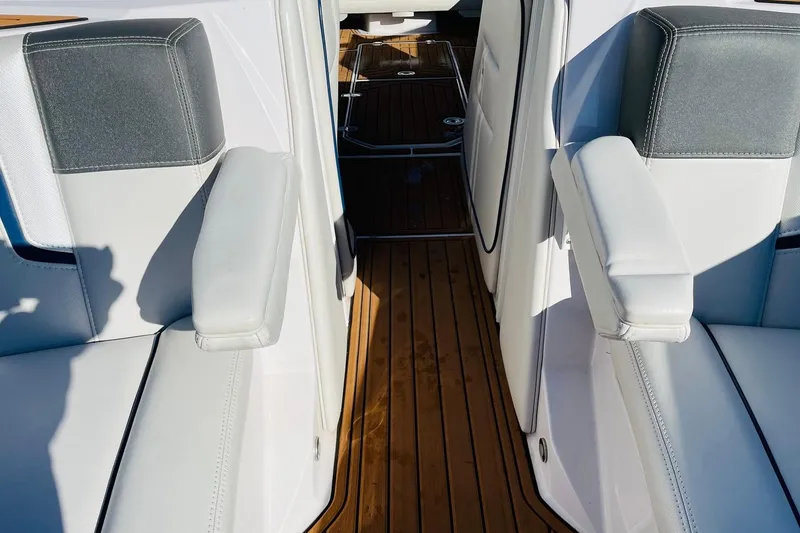 Slide: The Image of 2015 Nautique Super Air Nautique G23 interior with white leather seats and teak flooring. - 19