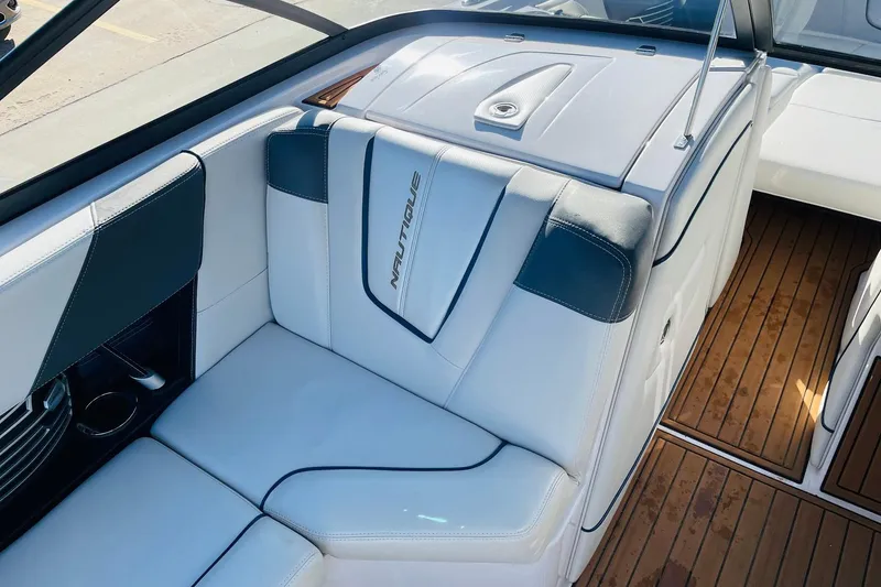 Slide: The Image of 2015 Nautique Super Air Nautique G23 interior with white leather seating and teak flooring. - 20