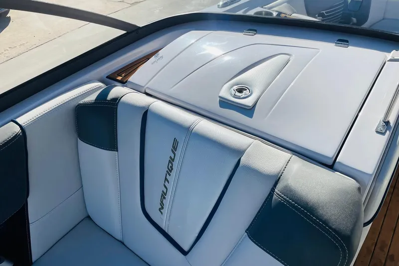 Slide: The Image of 2015 Nautique Super Air Nautique G23 boat interior with branded seating and storage compartment. - 23