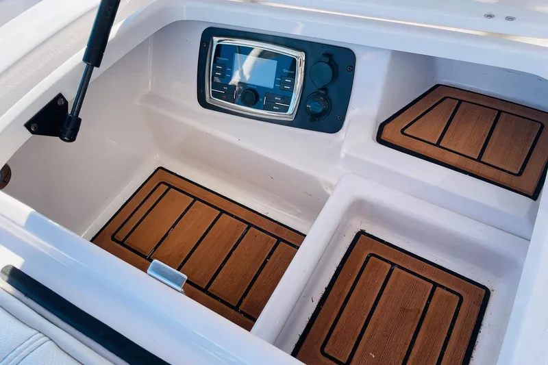 Slide: The Image of 2015 Nautique Super Air Nautique G23 dashboard with wooden accents and control panel. - 24