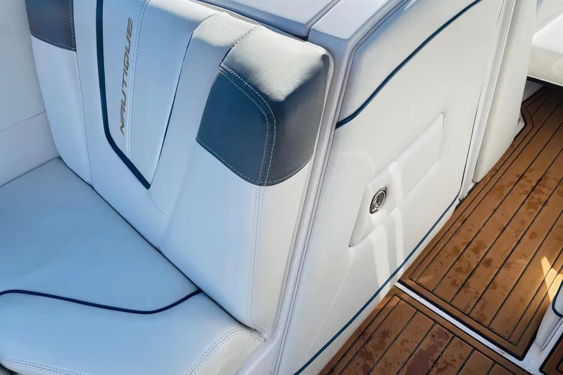 Slide: The Image of 2015 Nautique Super Air Nautique G23 interior with white upholstery and teak flooring. - 25