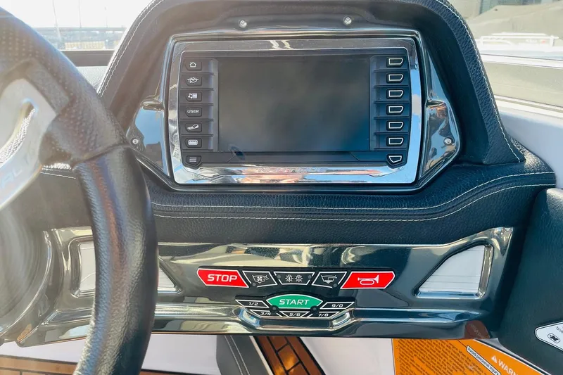 Slide: The Image of Dashboard of a 2015 Nautique Super Air Nautique G23 boat with control panel. - 29