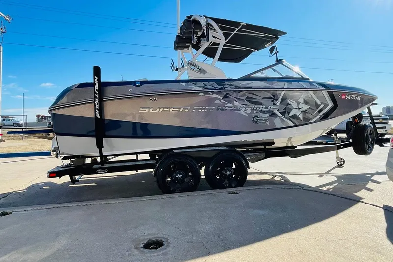 Slide: The Image of 2015 Nautique Super Air Nautique G23 boat on trailer, side view, sunny day. - 3