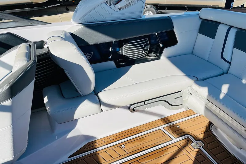 Slide: The Image of 2015 Nautique Super Air Nautique G23 interior with white seating and teak flooring. - 30