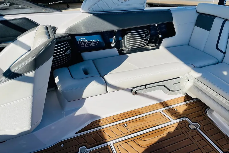 Slide: The Image of 2015 Nautique Super Air Nautique G23 interior with white seating and teak flooring. - 31