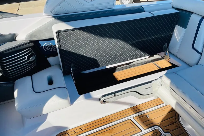 Slide: The Image of 2015 Nautique Super Air Nautique G23 interior with open storage compartment. - 32