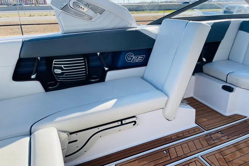 Slide: The Image of Interior of 2015 Nautique Super Air Nautique G23 with white seating and teak flooring. - 36