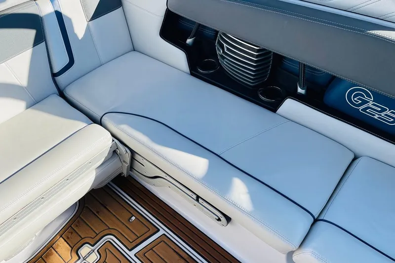 Slide: The Image of 2015 Nautique Super Air Nautique G23 interior seating with cup holders and teak flooring. - 37