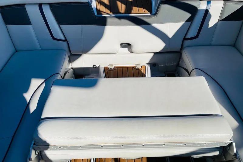 Slide: The Image of Interior seating of 2015 Nautique Super Air Nautique G23 boat, featuring white upholstery. - 40