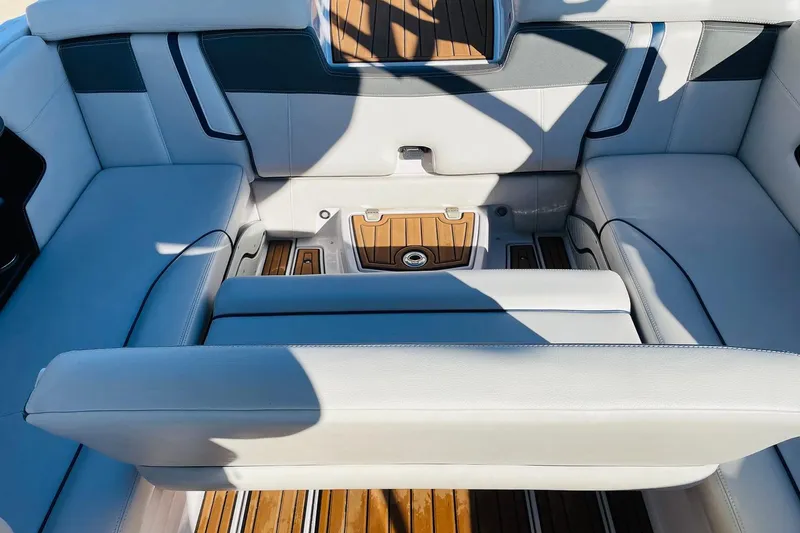 Slide: The Image of 2015 Nautique Super Air Nautique G23 interior with white seating and teak flooring. - 41