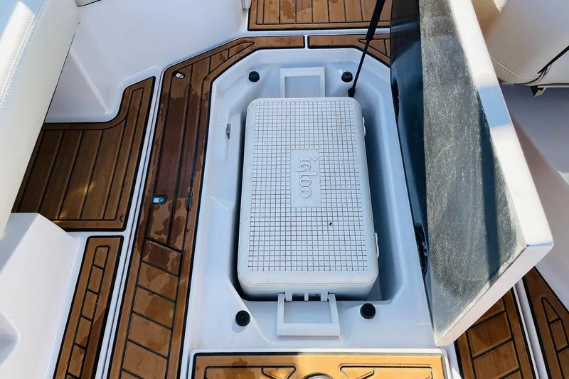 Slide: The Image of 2015 Nautique Super Air Nautique G23 interior with Igloo cooler and teak flooring. - 44