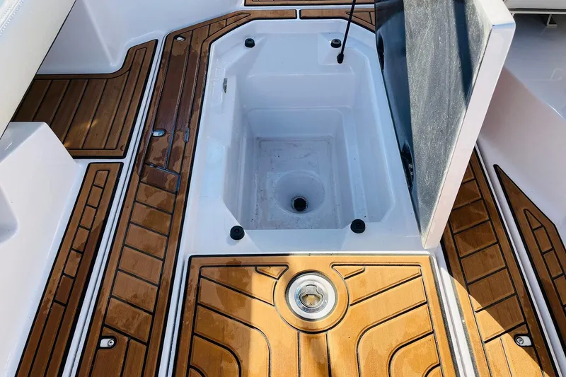 Slide: The Image of 2015 Nautique Super Air Nautique G23 boat interior with open storage compartment. - 45