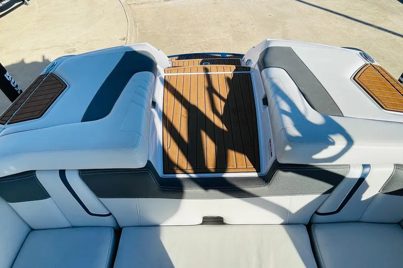 Slide: The Image of 2015 Nautique Super Air Nautique G23 boat interior with white and wood accents. - 46