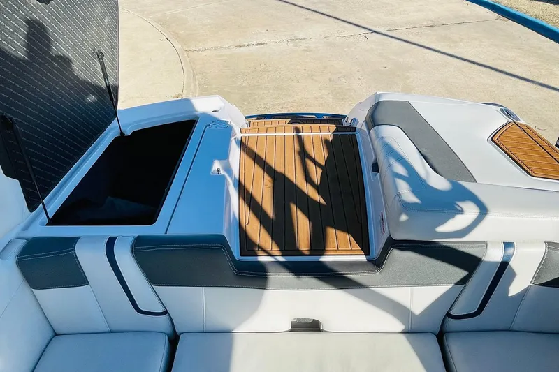 Slide: The Image of 2015 Nautique Super Air Nautique G23 boat interior with open storage and teak accents. - 47