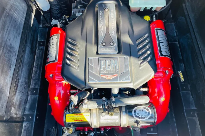 Slide: The Image of Engine of 2015 Nautique Super Air Nautique G23 with PCM branding and red components. - 50